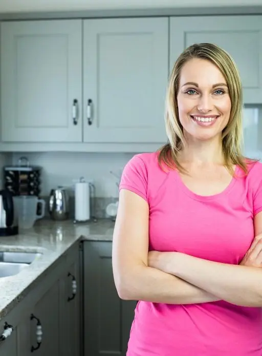 Brisbane Benchtops - Hawthorne woman looking confident and assured in new dream kitchen with beautiful benchtop