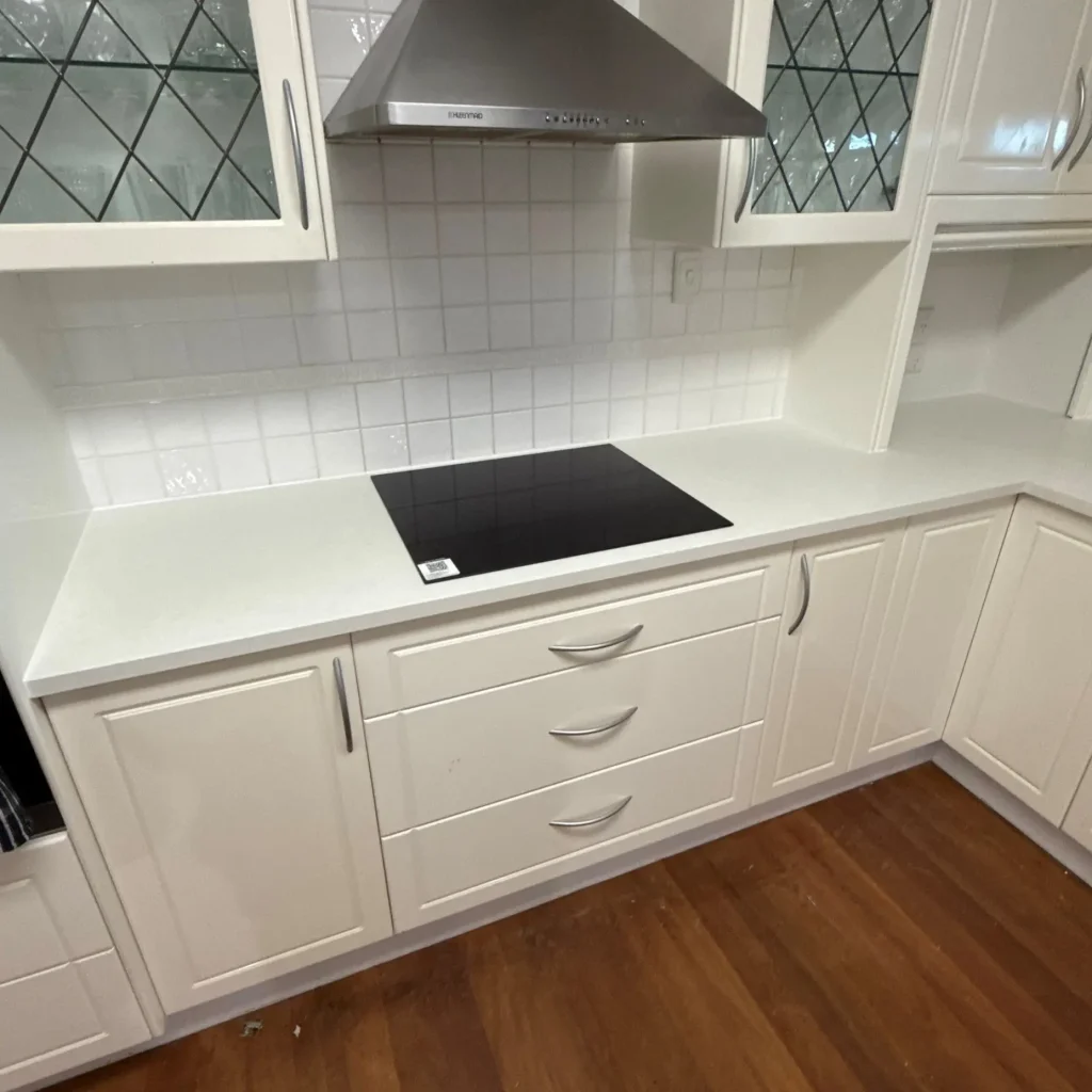 Modern white kitchen with new stone benchtop installation by Brisbane Benchtops in Kenmore, Brisbane